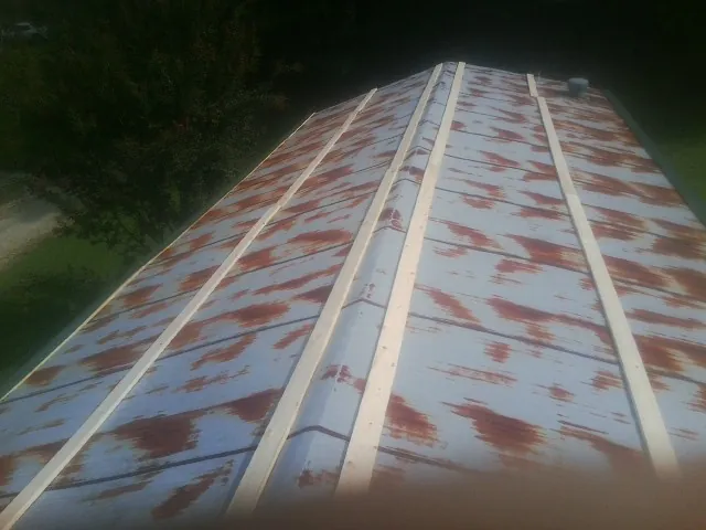 Rusted metal roof panels with new wood purlins before replacement — Storm Damage Roof Repair in Estill by Roofing Brothers